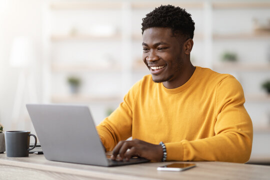 Man drinking and using laptop